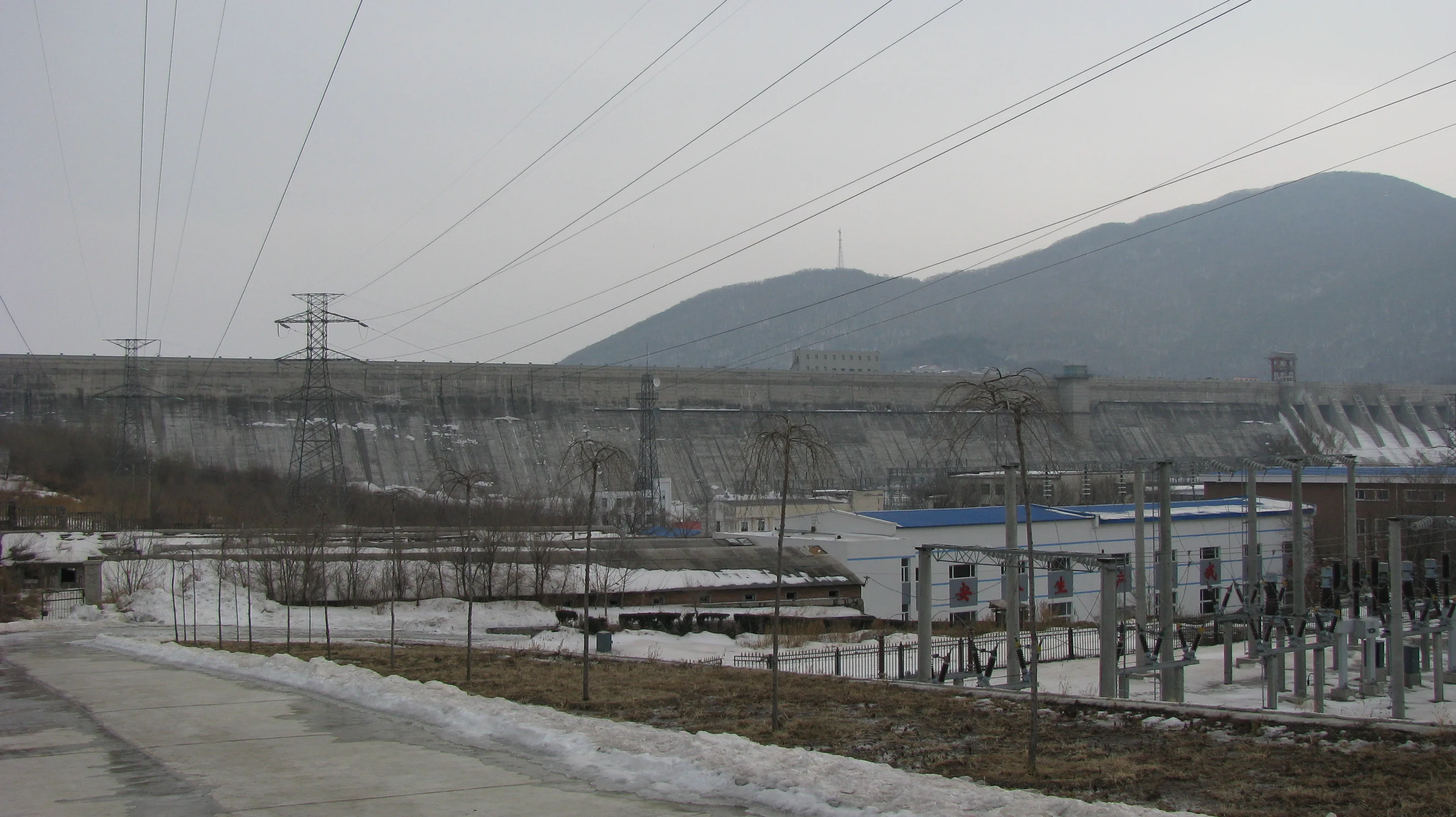 Fengman Dam on the Second Songhua River in Jilin, with mountains behind